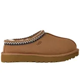 A tan slip-on clog with a thick sole, fur lining, and decorative trim, featuring the UGG logo.