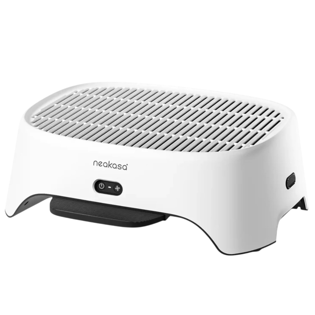 A white Neakasa pet dryer with a grated top and control buttons is designed to dry animals with adjustable airflow settings.