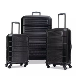 Three black hardshell suitcases of varying sizes with four spinner wheels and telescopic handles.