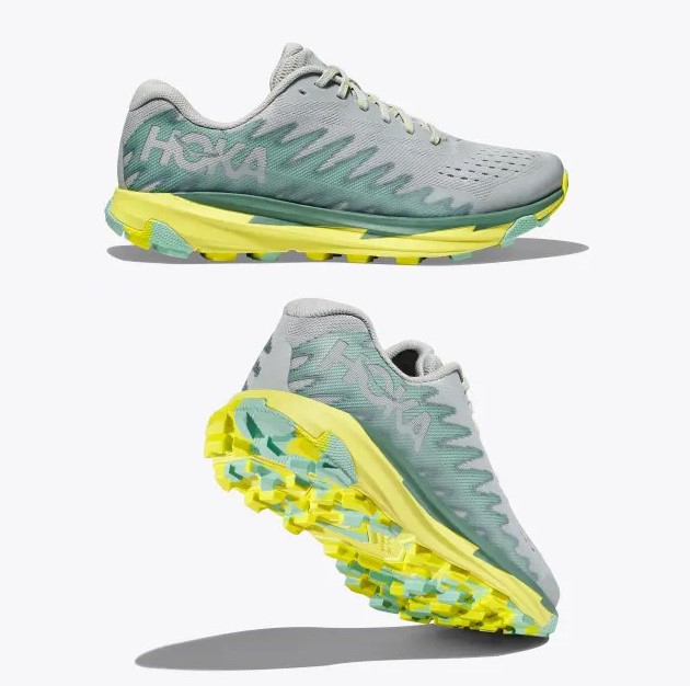 A pair of Hoka running shoes with a grey upper and yellow outsole.