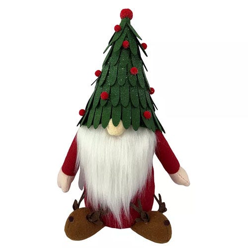 A plush gnome figure wearing a green Christmas tree hat with red accents, featuring a long white beard and brown shoes shaped like reindeer.