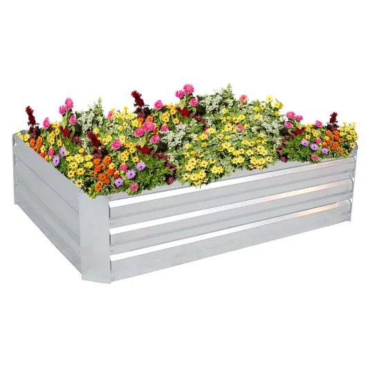 A raised garden bed made of metal, filled with a variety of colorful flowers including yellow, pink, orange, and purple blooms.