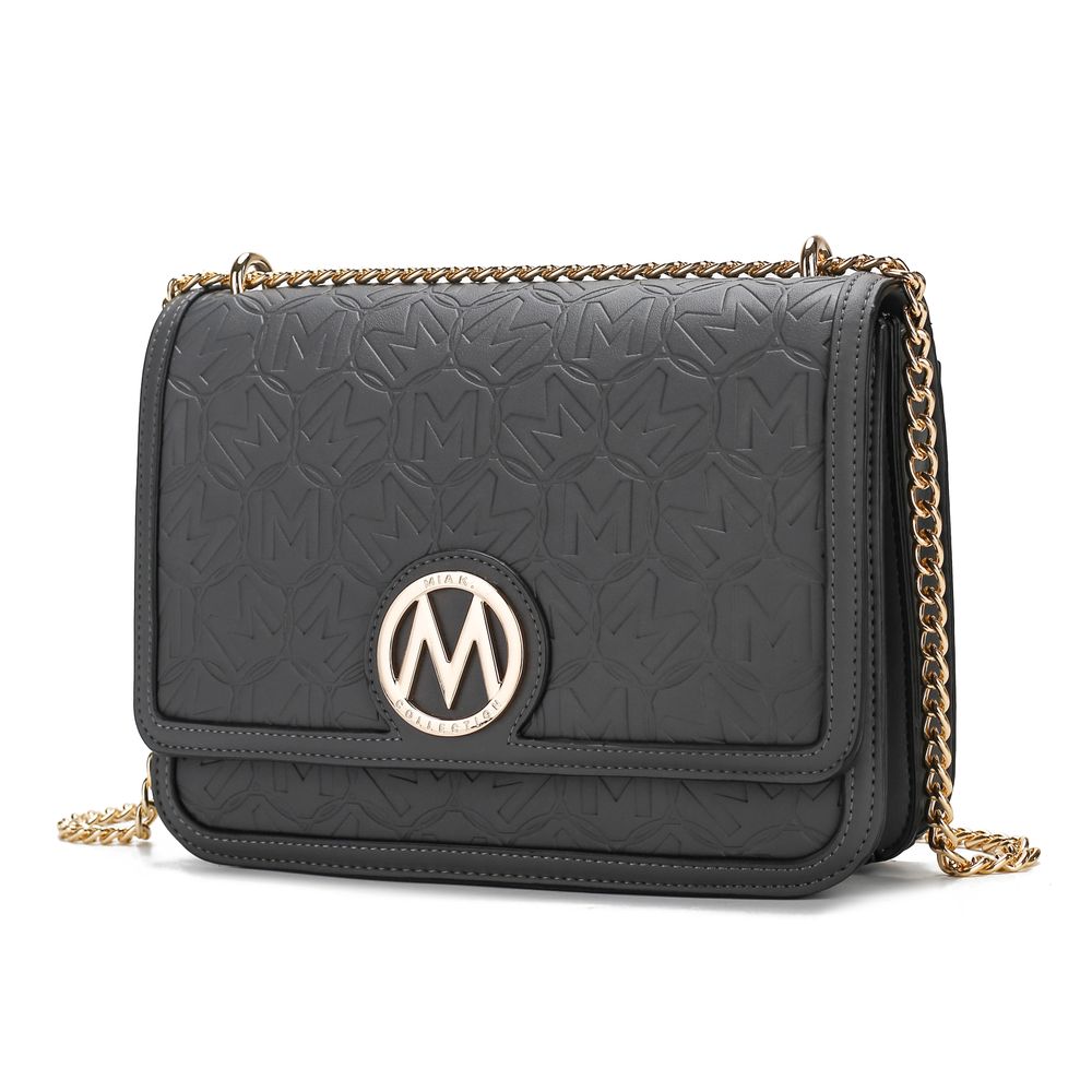 Black embossed shoulder bag with a gold chain strap and a circular emblem featuring the letter 'M'.