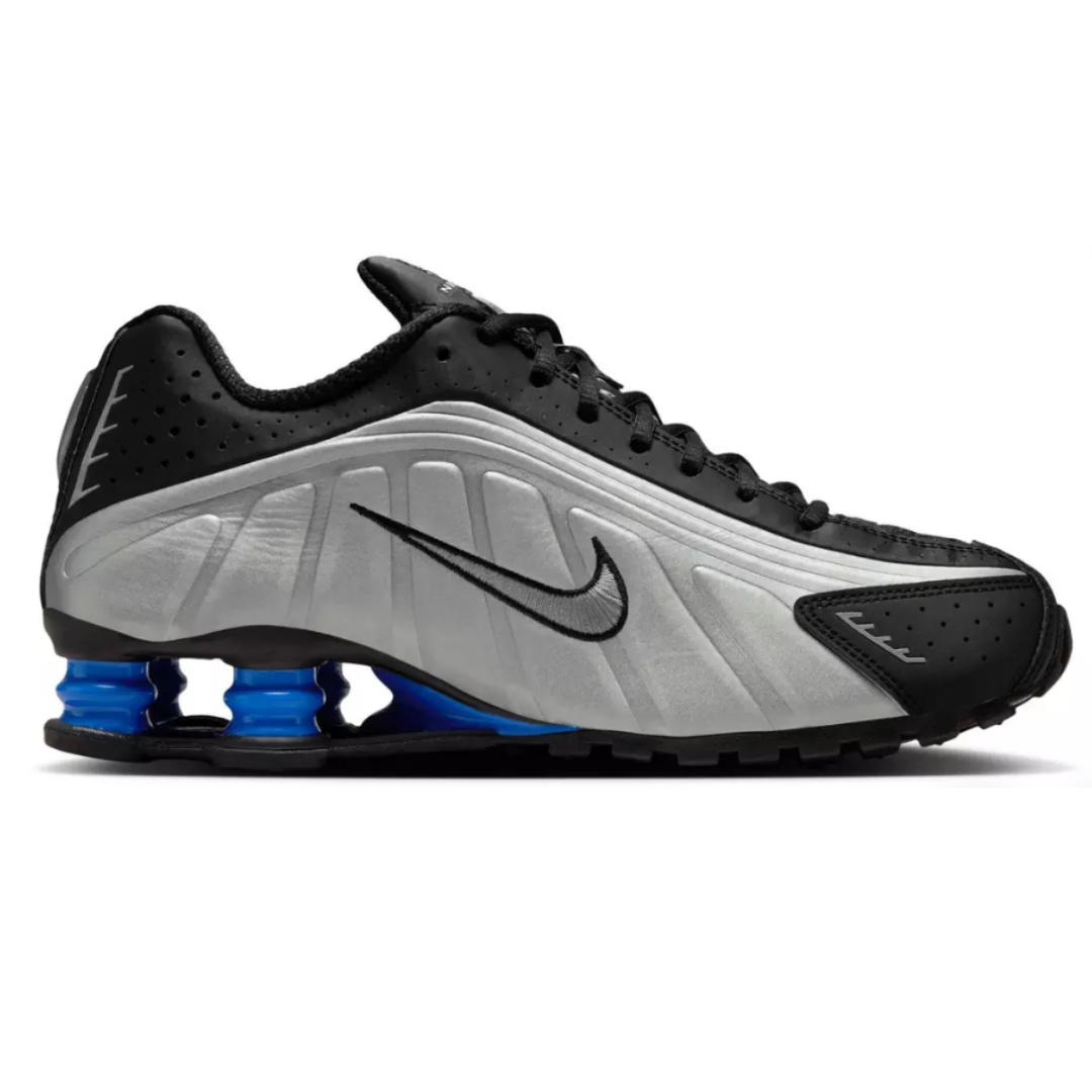 A Nike shoe featuring a silver and black design with a prominent Swoosh and blue spring-like cushioning in the sole.