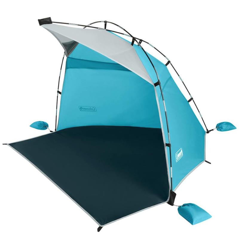 A compact, collapsible beach tent in blue with sandbag anchors and a sunscreen canopy for sun protection.