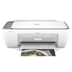 White HP DeskJet 2655 all-in-one printer with an open paper tray, printing a colorful document.