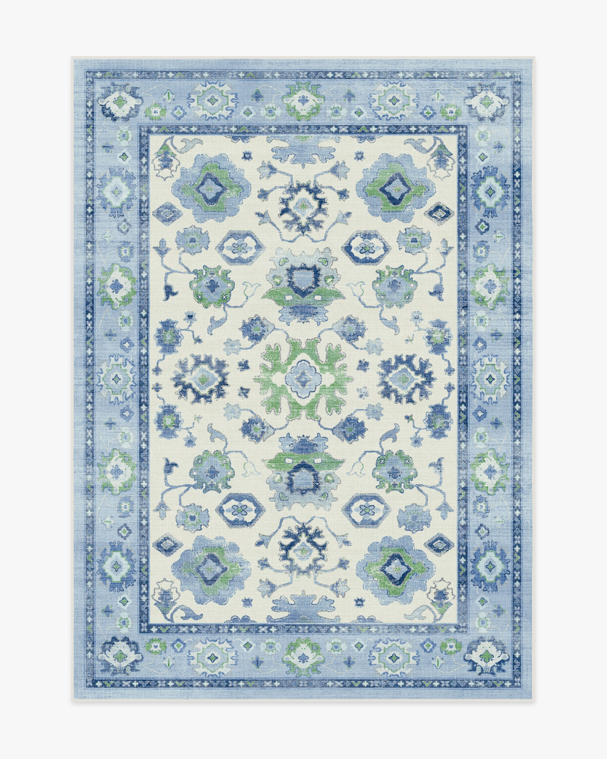 A rectangular area rug featuring a traditional floral and geometric pattern in shades of blue and green on a beige background with a decorative border.