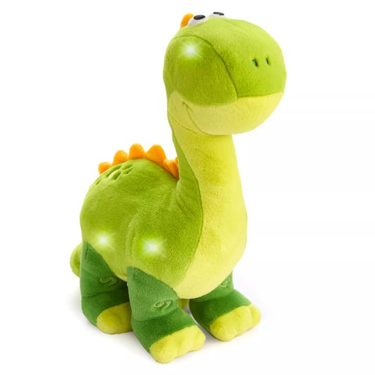 A green plush dinosaur toy with light-up features and orange spikes along its back.