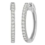 Silver hoop earrings encrusted with small round diamonds in a pave setting, adding elegance and sparkle.