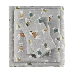 A flannel sheet set with a whimsical dog print, consisting of a Queen-sized flat sheet, fitted sheet, and pillowcases in gray and white tones.