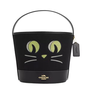 Black Coach bucket bag with a cat face design and a hanging brand tag.