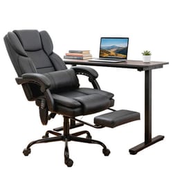 An ergonomic black office chair with footrest and an adjustable desk holding a laptop, plant, and books.