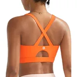 Orange sports bra with crisscross back straps and a keyhole design, featuring a small logo.