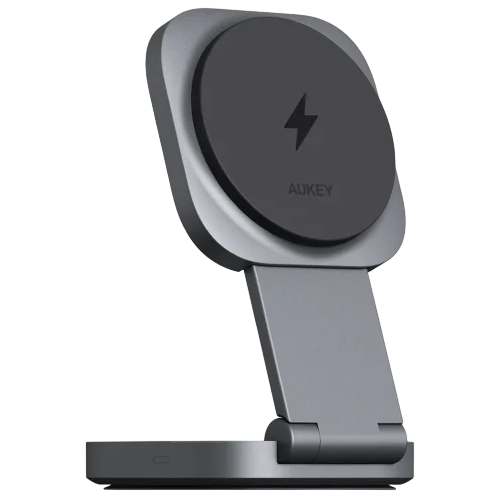 A foldable wireless charging stand featuring a circular charging pad with a lightning bolt symbol, branded with \“AUKEY\“, supported by a hinged arm on a rectangular base.