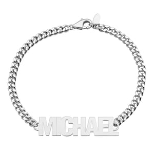 Men's Custom Nameplate Bracelet features a silver chain with a lobster clasp, showcasing a bold, polished nameplate that reads \“MICHAEL\“ in capital letters.