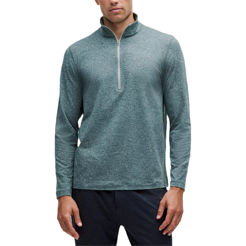 Lululemon Soft Jersey Half Zip Jacket is a long-sleeve, mid-layer top in a heathered blue-gray color, featuring a half-zip design and a standing collar. Ideal for layering in casual and athletic settings.