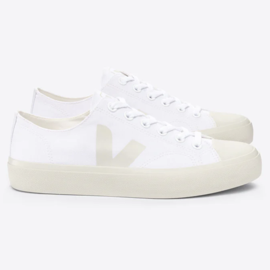 White low-top sneakers with a minimalist design, featuring a subtle logo on the side and cream-colored soles.