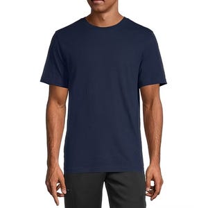 A man wearing a plain navy blue short-sleeve t-shirt and dark pants.