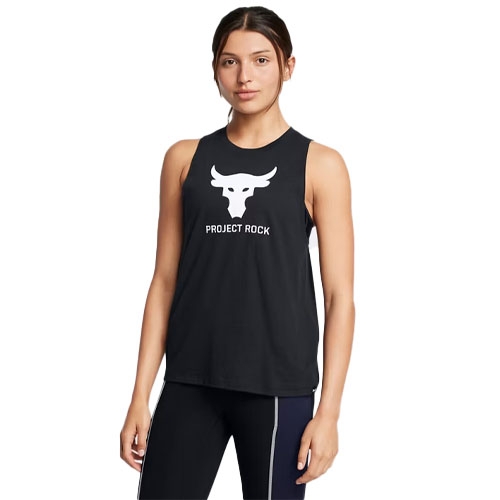 A woman is wearing a black sleeveless tank top with a white bull logo and \“PROJECT ROCK\“ text on the front. The tank is paired with dark leggings having light-colored stripes on the sides.