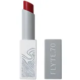 A lipstick with a red shade, housed in a sleek gray case with the brand name \“FLYTE.70\“ on the lid.