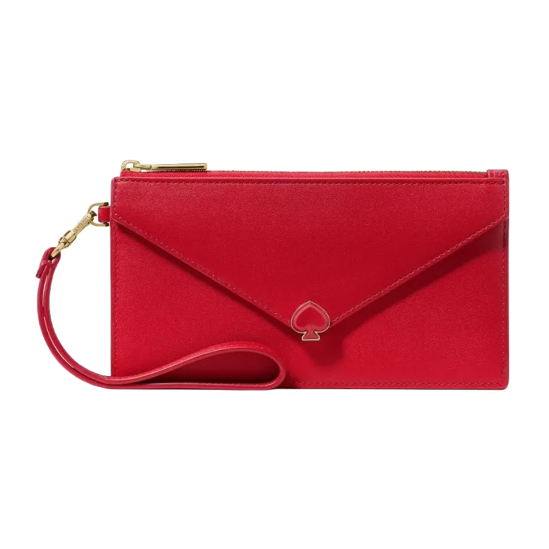 A red wristlet wallet featuring a spade emblem and an envelope-style front flap, with a gold zipper and a detachable strap for easy carrying.