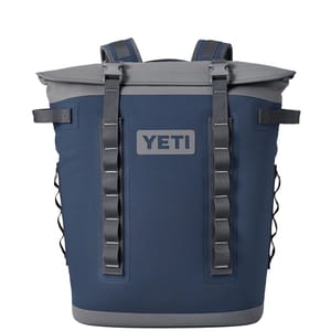 YETI backpack cooler in navy blue with gray accents, featuring shoulder straps and multiple attachment loops.