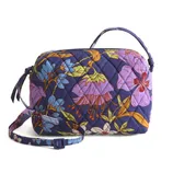 A floral-patterned quilted fabric bag with a purple background, featuring a top handle and an adjustable shoulder strap.