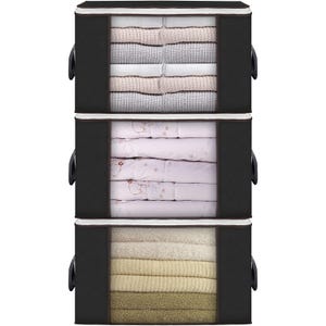 A three-tier black storage organizer containing folded sweaters, shirts, and towels.