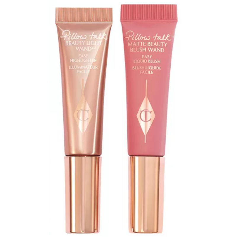 The Charlotte Tilbury Blush & Glow Set includes a Beauty Light Wand Easy Highlighter in a shimmer finish and a Matte Beauty Blush Wand in a soft pink shade, both in squeeze tube packaging with rose gold caps.