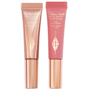 The Charlotte Tilbury Blush & Glow Set includes a Beauty Light Wand Easy Highlighter in a shimmer finish and a Matte Beauty Blush Wand in a soft pink shade, both in squeeze tube packaging with rose gold caps.