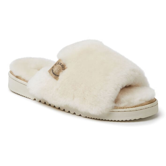 The Dearfoams Shearling Slippers are cozy, open-toe slides with a plush, white shearling upper and a durable sole. They feature a small logo patch on the side, providing both comfort and style for indoor use.