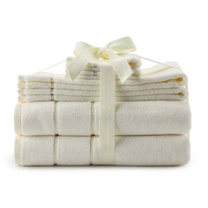 Six-piece Organic Turkish Cotton Towel Set in cream, neatly stacked and tied with a matching ribbon; includes two bath towels, two hand towels, and two washcloths.