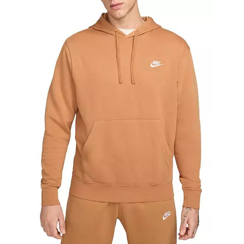 A tan Nike Club Fleece Hoodie with a kangaroo pocket, adjustable drawstring hood, and white Nike logo on the chest. It's paired with matching sweatpants featuring a similar logo.