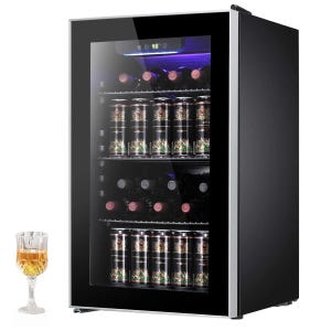 A modern glass-door beverage cooler, stocked with wine bottles and canned drinks, is displayed alongside a filled glass on the side.
