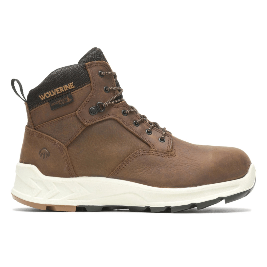 Brown leather work boot with a white sole, featuring \“Wolverine\“ branding, waterproof technology, and metal eyelets.