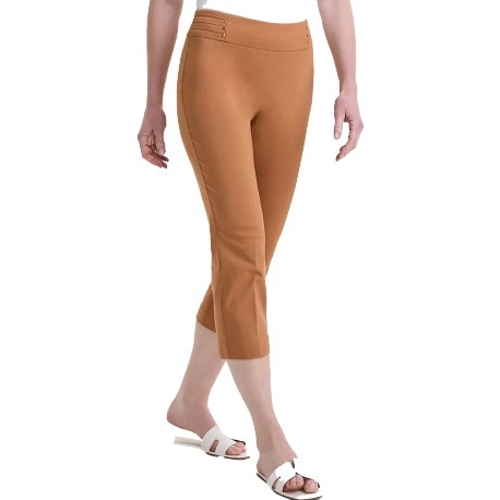 A person wearing tan capri pants paired with white slide sandals.