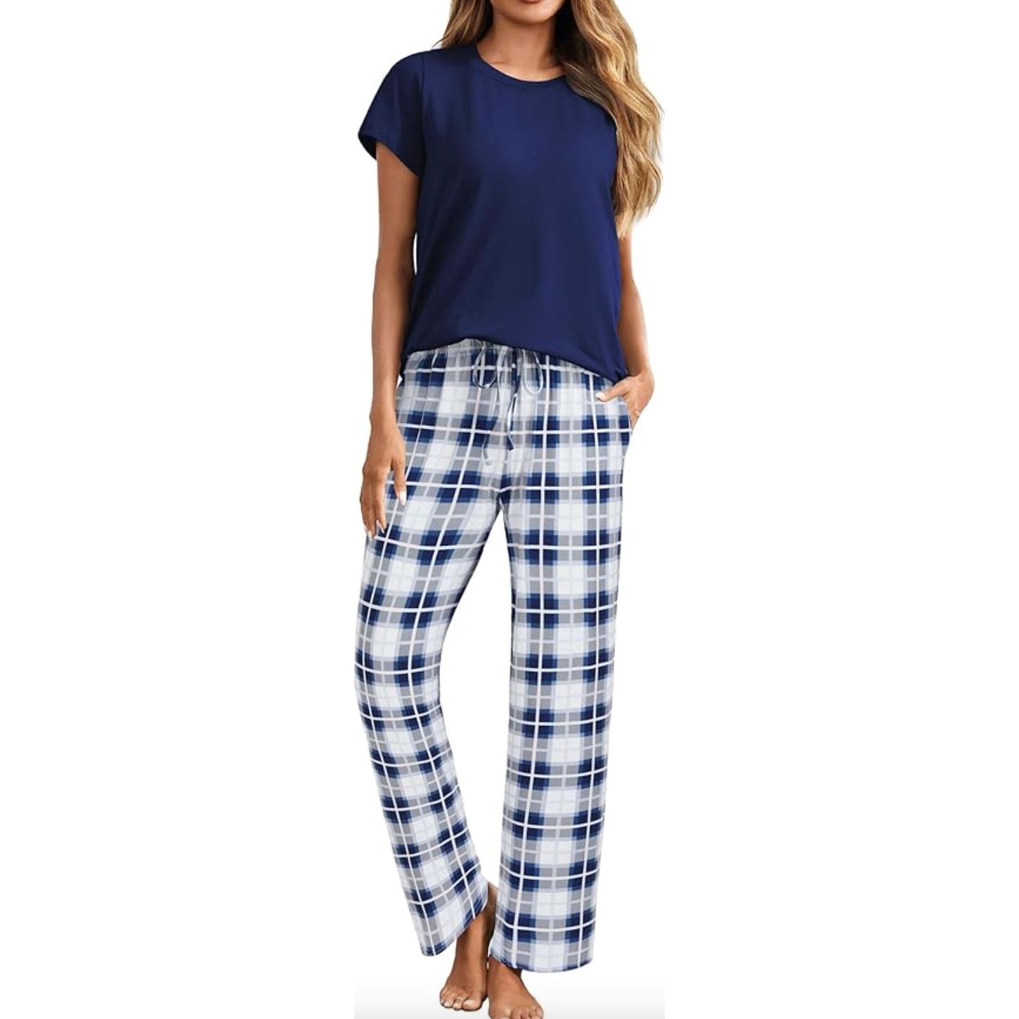 Women's pajamas featuring a short-sleeve, navy blue top paired with white and navy plaid pants, complete with a drawstring waistband.