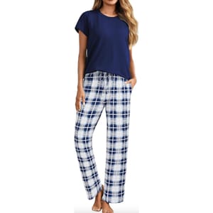 Women's pajamas featuring a short-sleeve, navy blue top paired with white and navy plaid pants, complete with a drawstring waistband.