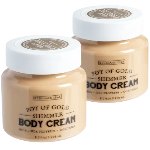 Two jars of Beekman 1802 Pot of Gold Shimmer Body Cream, featuring mica, silk proteins, and goat milk, each with an 8.0 fl oz (236 ml) capacity.