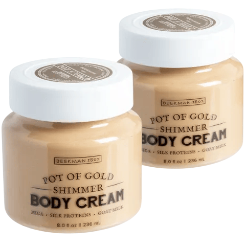 Two jars of Beekman 1802 Pot of Gold Shimmer Body Cream, featuring mica, silk proteins, and goat milk, each with an 8.0 fl oz (236 ml) capacity.