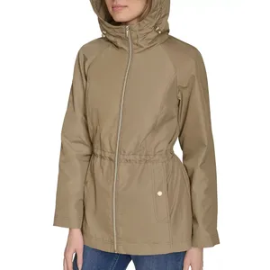 Beige hooded jacket with a front zipper, drawstring waist, and two front pockets, worn over blue jeans.