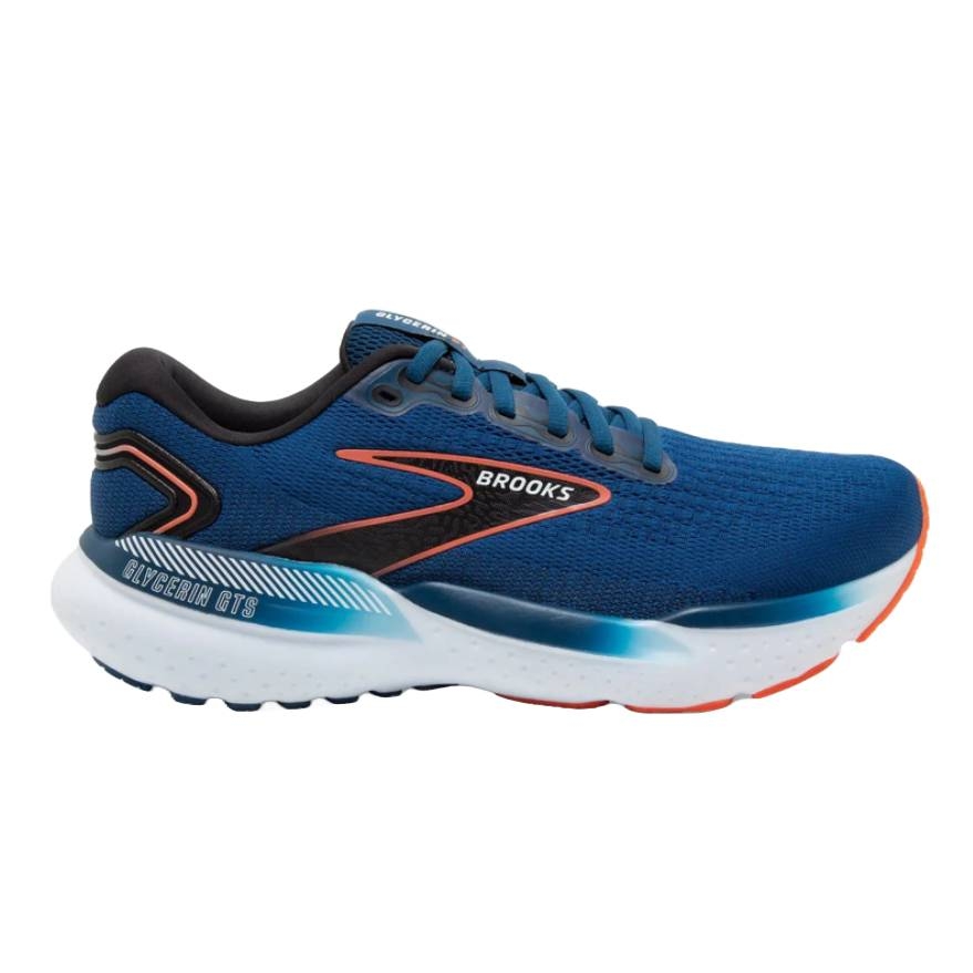 Brooks Glycerin GTS 21 Running Shoes feature a blue upper with black and orange accents, a cushioned white sole with blue highlights, and are designed for stability and comfort.