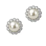 A pair of earrings featuring large central pearls surrounded by a scalloped halo of sparkling diamonds.