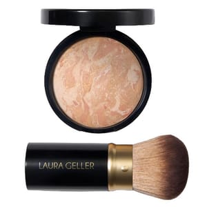 Compact face powder with a marbled design in a black round compact, paired with a retractable kabuki brush labeled \“Laura Geller.\“
