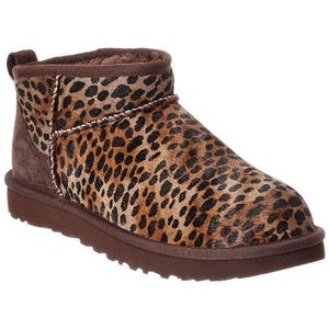 A leopard print, ankle-high boot with a brown sole and trim.