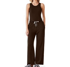 A women's 2-piece loungewear set featuring a sleeveless brown tank top and matching wide-leg pants with an elastic waistband and white drawstring. Paired with checkered slippers.