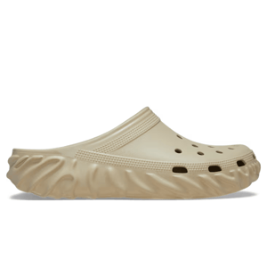 A beige slip-on clog with a textured sole and ventilation holes on the top.
