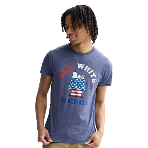 A person is wearing a blue t-shirt featuring Snoopy with a red, white, and blue theme and the words \“RED, WHITE & CHILI.\“