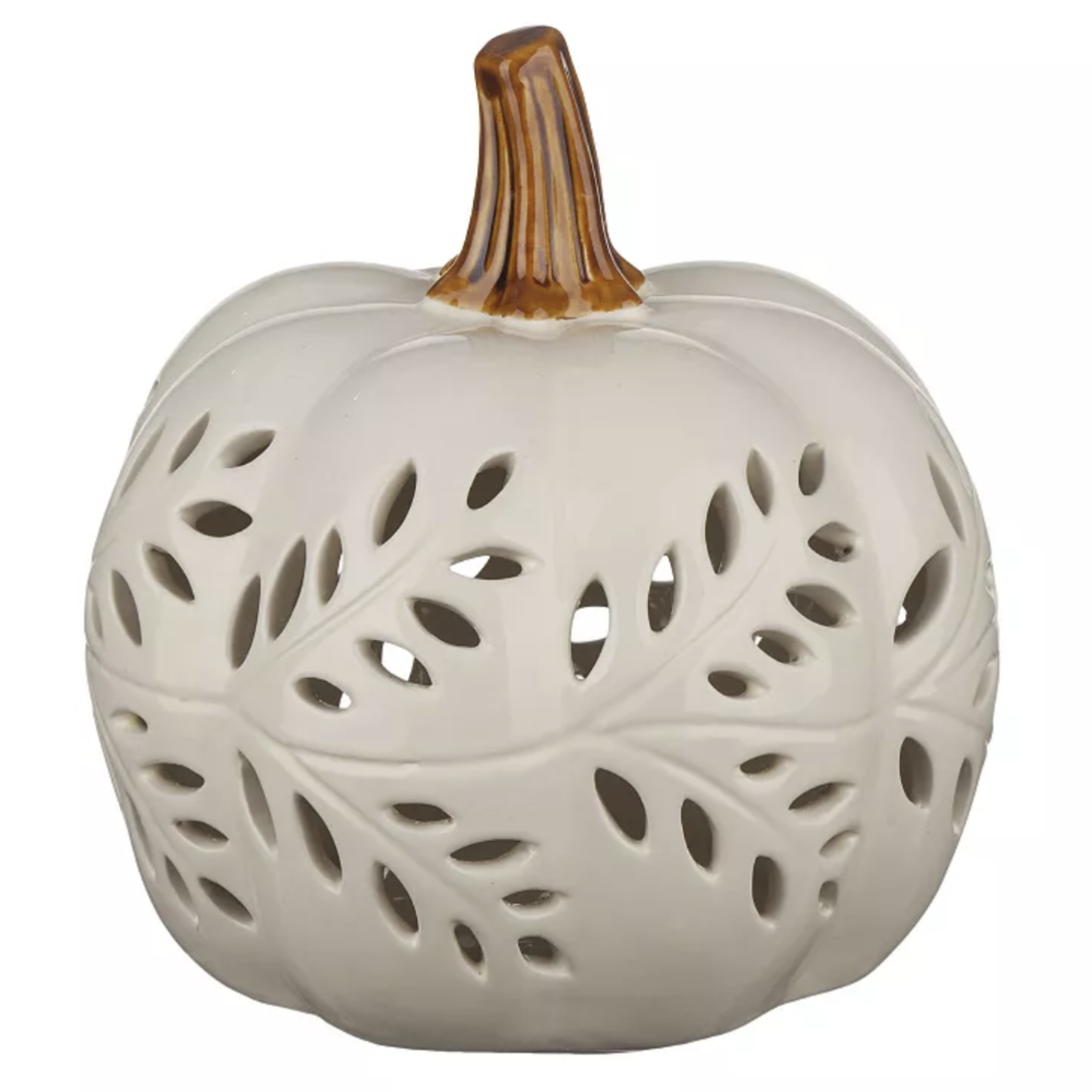 White ceramic pumpkin lantern with leaf cutout design and brown stem, ideal for decorative lighting.