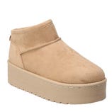 A beige suede boot with a thick platform sole, designed for a slip-on style.